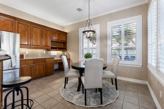 dining area with visible vents, baseboards, a notable chandelier, ornamental molding, and light tile patterned flooring