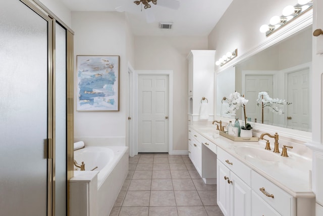 bathroom with a sink, tile patterned flooring, double vanity, visible vents, and a bath
