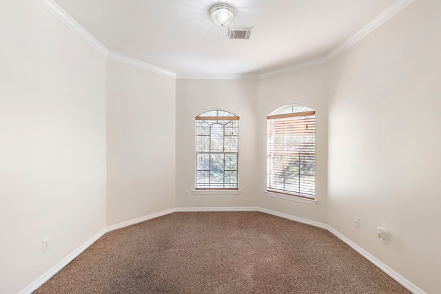 spare room featuring carpet flooring, baseboards, visible vents, and ornamental molding
