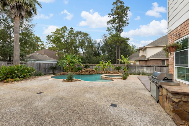 view of swimming pool featuring a fenced backyard, a patio, an in ground hot tub, and grilling area