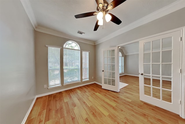 empty room with baseboards, ornamental molding, french doors, and wood finished floors