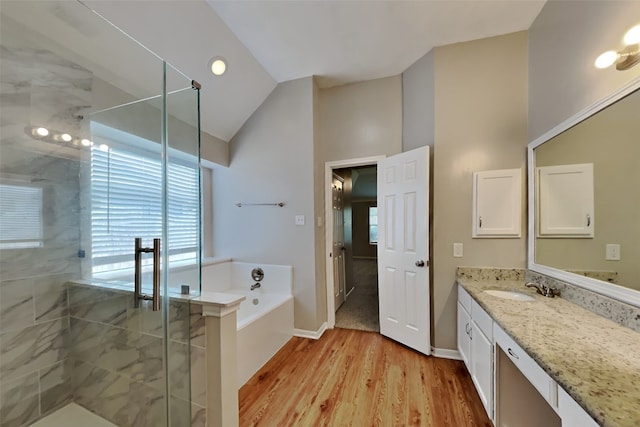full bathroom featuring a bath, wood finished floors, a wealth of natural light, and a shower stall