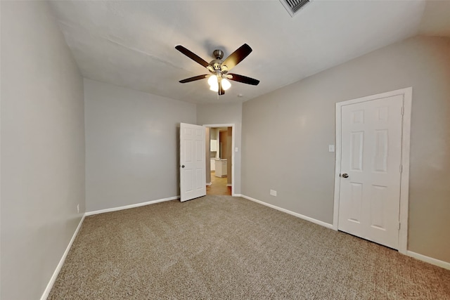 unfurnished bedroom with baseboards, carpet flooring, ceiling fan, and visible vents