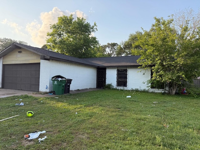 view of property exterior with brick siding, a garage, and a lawn