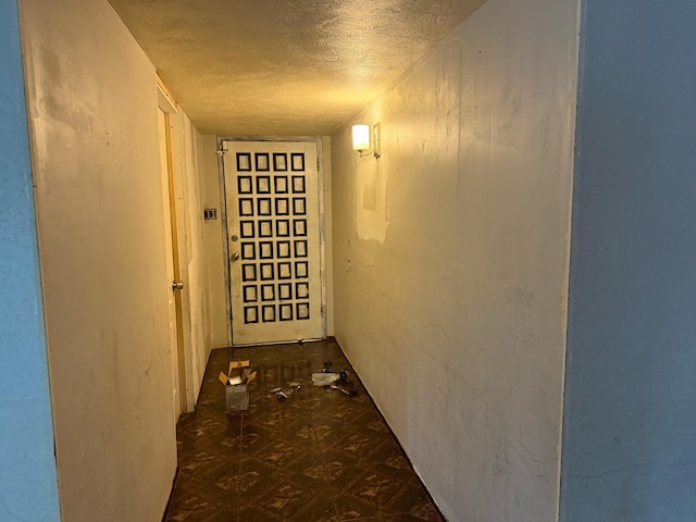 hallway with a textured ceiling