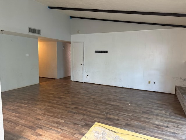 empty room featuring visible vents, beam ceiling, high vaulted ceiling, and wood finished floors