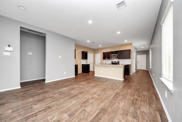 22619 Goose Pasture Ln, Spring, TX 77373 - unfurnished living room with dark wood-style flooring and recessed lighting