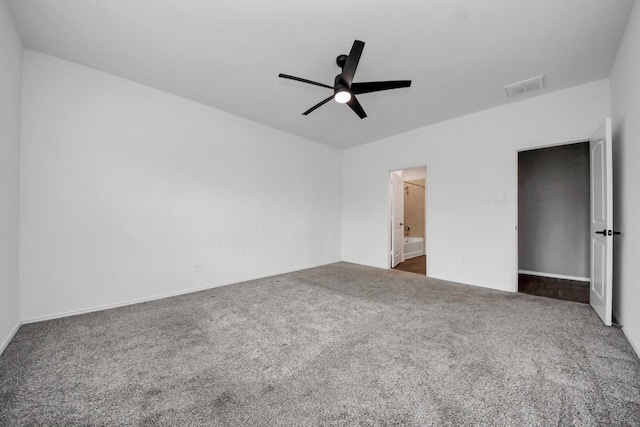 22619 Goose Pasture Ln, Spring, TX 77373 - unfurnished bedroom with dark carpet, ensuite bathroom, and a ceiling fan