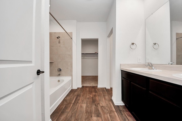 22619 Goose Pasture Ln, Spring, TX 77373 - bathroom with double vanity, shower / bath combination, wood finished floors, and a spacious closet