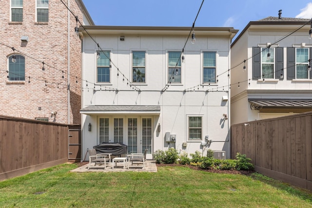 back of property with a lawn, a fenced backyard, a patio area, and stucco siding