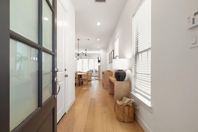 hall featuring recessed lighting, baseboards, light wood-type flooring, and visible vents