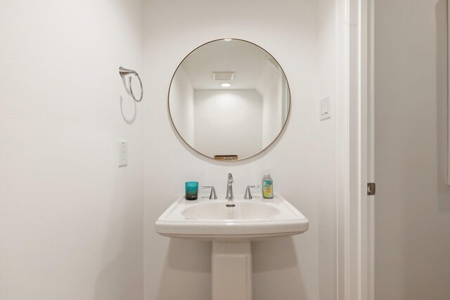 bathroom with visible vents and a sink