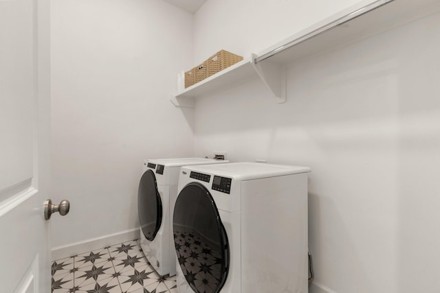 clothes washing area featuring baseboards, laundry area, and independent washer and dryer