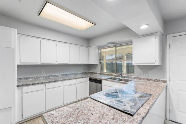 kitchen with recessed lighting, a sink, white cabinetry, and dishwasher