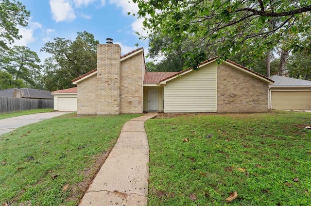 mid-century modern home featuring driveway, a chimney, a tile roof, a front yard, and fence