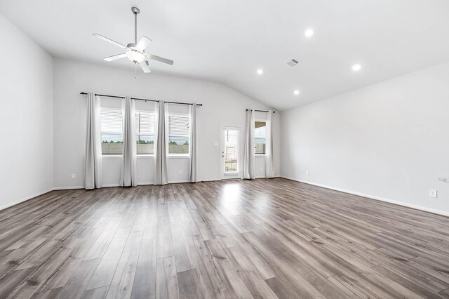 unfurnished living room with a ceiling fan, recessed lighting, wood finished floors, lofted ceiling, and visible vents
