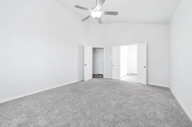 unfurnished bedroom with a ceiling fan, baseboards, carpet, and high vaulted ceiling