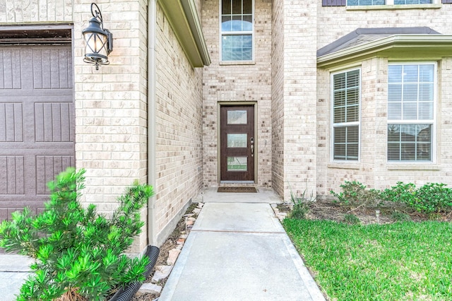 property entrance featuring brick siding