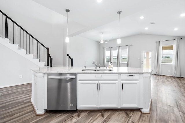 kitchen featuring a sink, stainless steel dishwasher, an island with sink, and a healthy amount of sunlight
