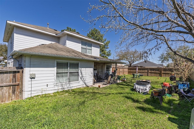 back of property featuring a fenced backyard, an outdoor fire pit, a patio area, and a yard