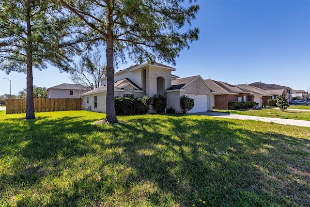 view of front of property featuring a front yard, a garage, brick siding, fence, and concrete driveway