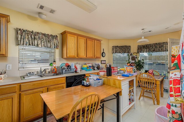 2103 Laurel Arbor Dr, Houston, TX 77014 - kitchen with plenty of natural light, light countertops, light tile patterned floors, and brown cabinetry