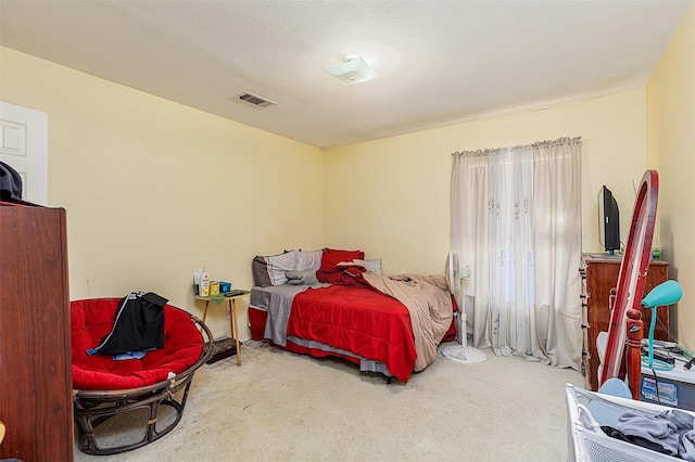 carpeted bedroom featuring visible vents