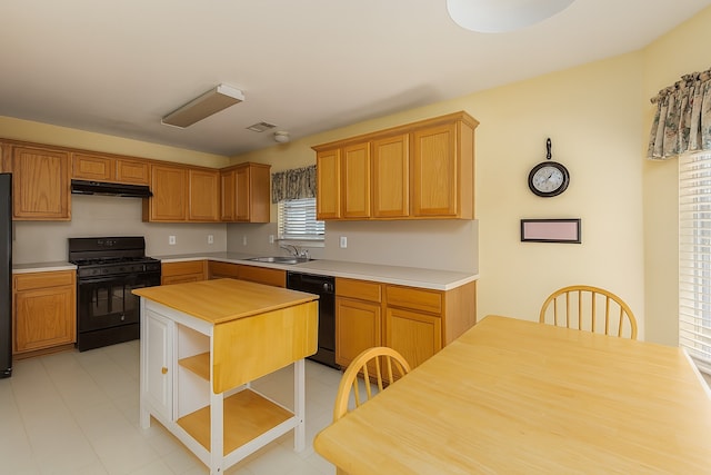 2103 Laurel Arbor Dr, Houston, TX 77014 - kitchen with black appliances, light countertops, under cabinet range hood, open shelves, and a kitchen island