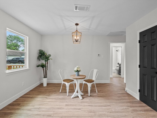 5225 Main St, Santa Fe, TX 77510 - dining area featuring baseboards, visible vents, an inviting chandelier, and light wood-style flooring