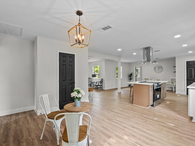 5225 Main St, Santa Fe, TX 77510 - kitchen featuring light countertops, visible vents, island exhaust hood, and stainless steel range with electric cooktop