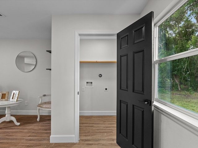 5225 Main St, Santa Fe, TX 77510 - laundry room with light wood-style floors, baseboards, hookup for an electric dryer, and hookup for a washing machine