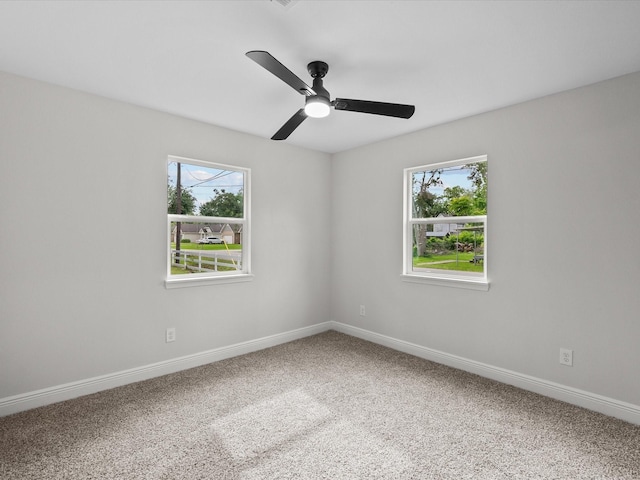 5225 Main St, Santa Fe, TX 77510 - empty room featuring carpet floors, baseboards, ceiling fan, and a wealth of natural light