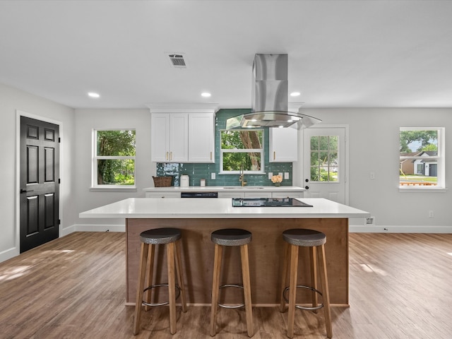 5225 Main St, Santa Fe, TX 77510 - kitchen with a sink, baseboards, island range hood, visible vents, and black appliances