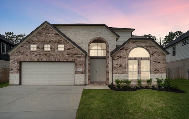 1904 Golden Spruce Ln, Conroe, TX 77301 - french country style house featuring brick siding, a front lawn, stone siding, and concrete driveway