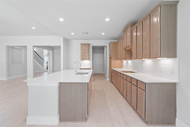 1904 Golden Spruce Ln, Conroe, TX 77301 - kitchen featuring baseboards, a center island with sink, recessed lighting, a sink, and backsplash