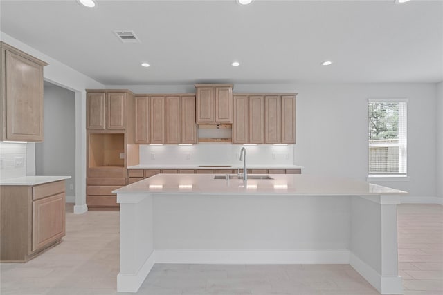 1904 Golden Spruce Ln, Conroe, TX 77301 - kitchen featuring a sink, light countertops, an island with sink, tasteful backsplash, and visible vents