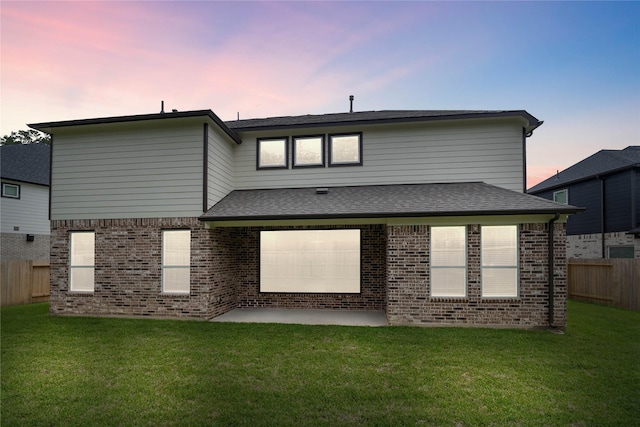 1904 Golden Spruce Ln, Conroe, TX 77301 - rear view of house with a lawn, brick siding, fence, and a patio area