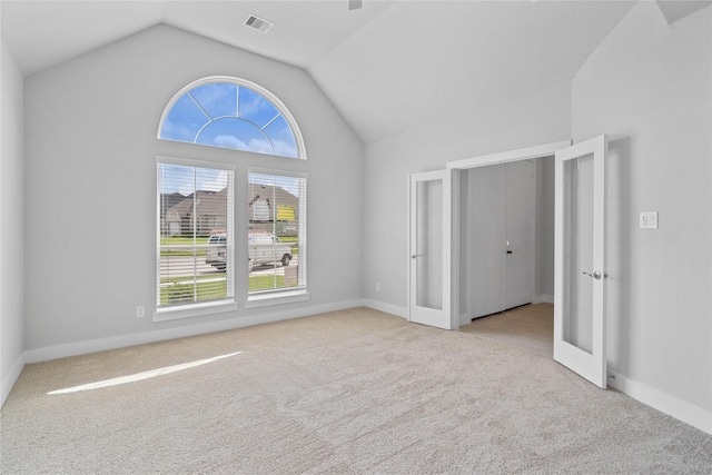 1904 Golden Spruce Ln, Conroe, TX 77301 - empty room featuring visible vents, baseboards, lofted ceiling, and carpet