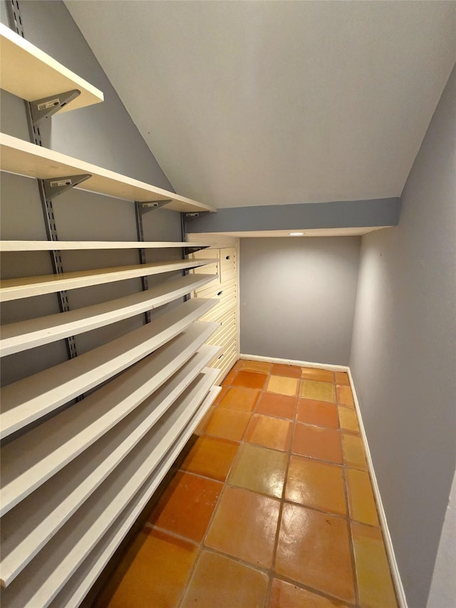 spacious closet with tile patterned floors and lofted ceiling