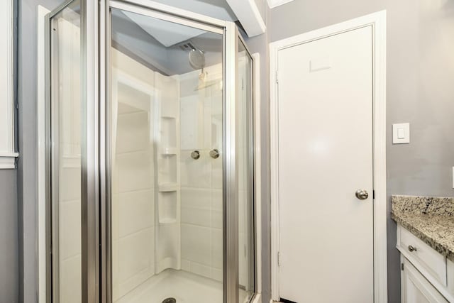 bathroom featuring vanity and a stall shower