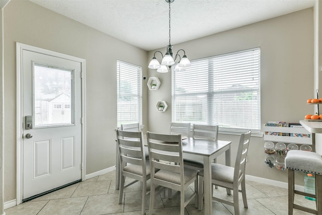 9322 Colt Canyon Ln, Houston, TX 77089 - dining area featuring a chandelier, light tile patterned floors, and a textured ceiling