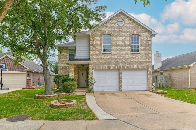 9322 Colt Canyon Ln, Houston, TX 77089 - traditional-style house featuring brick siding, concrete driveway, an attached garage, and an outdoor fire pit