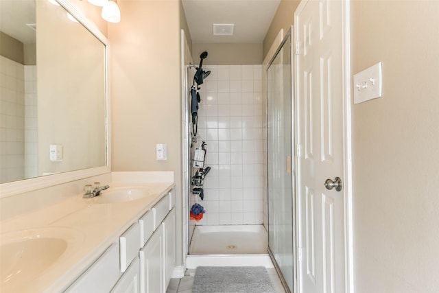 9322 Colt Canyon Ln, Houston, TX 77089 - bathroom featuring tiled shower, double vanity, and tile patterned floors