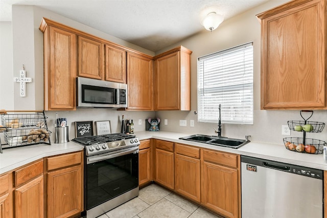 9322 Colt Canyon Ln, Houston, TX 77089 - kitchen featuring appliances with stainless steel finishes, light countertops, and light tile patterned floors