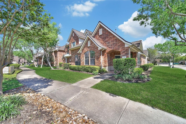 view of front of property featuring brick siding and a front lawn