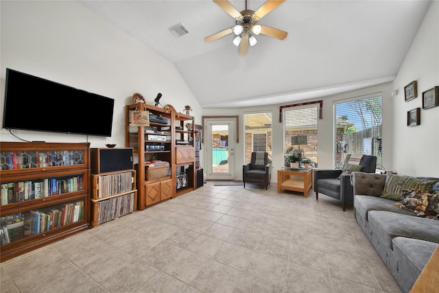 tiled living room featuring visible vents, ceiling fan, and lofted ceiling