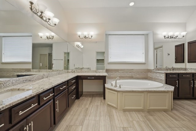 23 Castello Ln, Missouri City, TX 77459 - full bathroom featuring vanity, a chandelier, a bath, and lofted ceiling