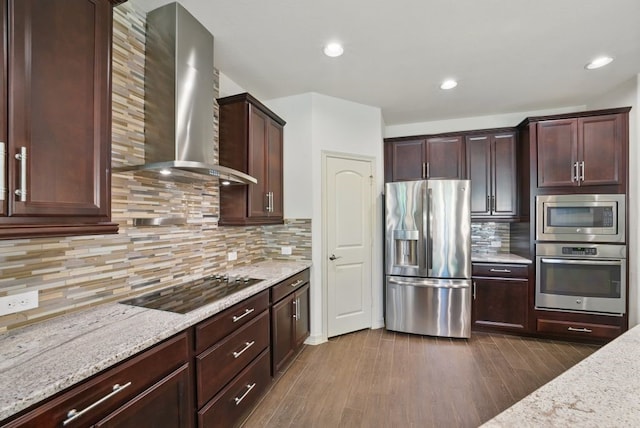 23 Castello Ln, Missouri City, TX 77459 - kitchen featuring stainless steel appliances, light stone countertops, wall chimney exhaust hood, and tasteful backsplash