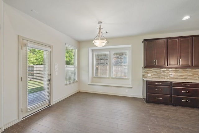 23 Castello Ln, Missouri City, TX 77459 - unfurnished dining area featuring baseboards and dark wood finished floors