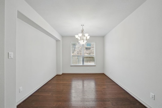 23 Castello Ln, Missouri City, TX 77459 - unfurnished dining area featuring baseboards, wood finished floors, and a chandelier
